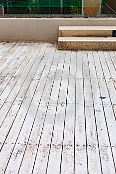 Wooden floor tiled outdoor beside swimming pool