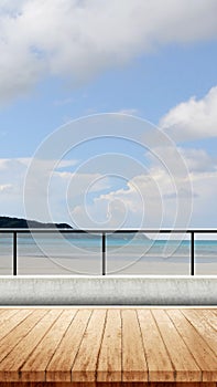 Wooden floor with a view of sandy beach with the blue ocean