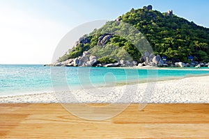 Wooden floor with white sand beach island and blur mountain hill background landscape