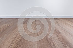 Wooden floor with white wall and floor skirting