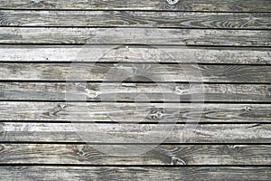Wooden floors of the terrace on the river bank. Texture of wet unpainted wood