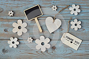 Wooden flowers and heart with calk board on a old wooden background with empty space layout