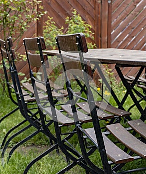 Wooden folding chairs at a table in a beer garden