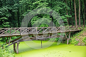 Wooden foot bridge over pond in Halych Ethnography museum, Ukraine photo