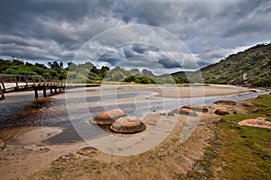 Wooden footbridge across Tidal River on stormy weather. Wilsons