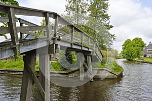 Wooden footbridge over the Dokkumer Ee in town of Bartlehiem