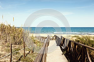 Wooden footbridge over dunes to the beach