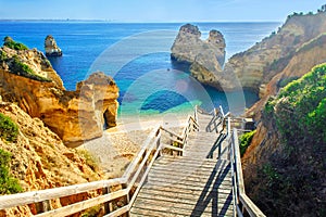 Wooden footbridge to beautiful beach Praia do Camilo near Lagos