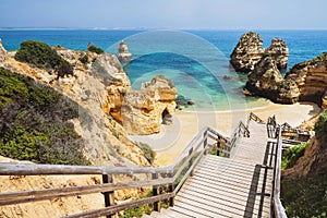 Wooden footbridge to beautiful beach Praia do Camilo near Lagos in Algarve region, Portugal