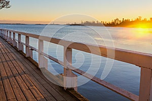 Wooden footbridge to sea at sunset.