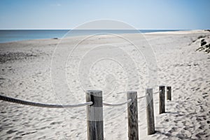 Wooden footpath through dunes at the ocean beach in Portugal