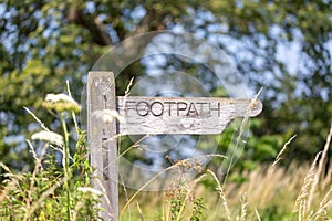 A wooden footpath sign in the English countryside