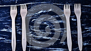 Wooden fork lying on a wooden table. Cutlery for eating. Device photo