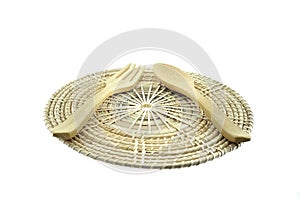 Wooden fork and spoon on rattan placemat