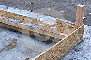 Wooden formwork with cement mortar for laying bricks and blocks