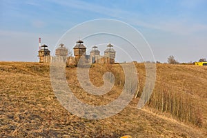 Wooden fortress in the field, old Russian wooden structure, village tower in the field