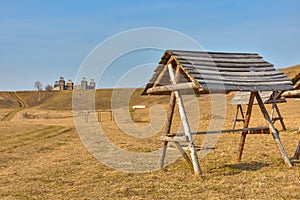 Wooden fortress in the field, old Russian wooden structure, village tower in the field