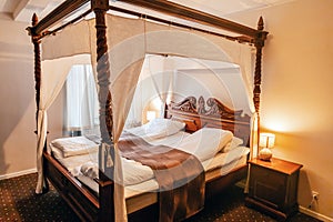 Wooden four-poster bed in a hotel room