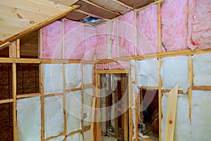 Wooden frame for future walls insulated with rock wool and fiberglass insulation