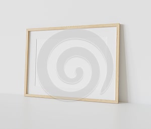 Wooden frame leaning on white floor in interior mockup. Template of a picture framed on a wall 3D rendering