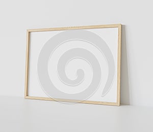 Wooden frame leaning on white floor in interior mockup. Template of a picture framed on a wall 3D rendering