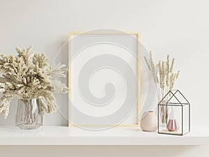 Wooden frame leaning on white shelf in bright interior with plants on the table with plants in pots on empty wall background