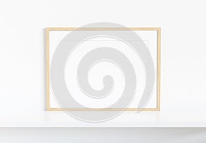 Wooden frame leaning on white shelve in bright interior mockup 3D rendering