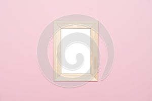 Wooden frame mock up on pastel pink background.