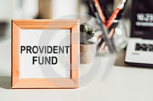 Wooden frame with office background with text PROVIDENT FUND