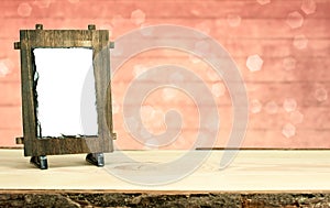 Wooden frame on table with bokeh background