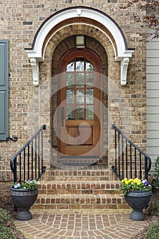 Wooden front door of family home with arch