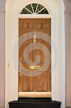 Wooden front door of family home with arch