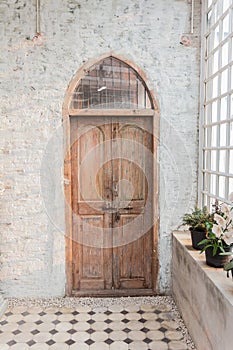 The wooden front door of a home with glass panels