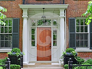 Wooden front door of house with portico entrance