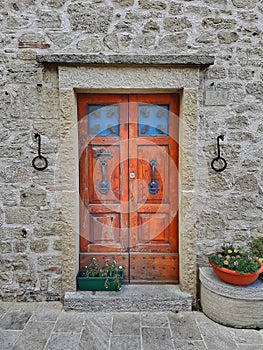 Wooden front door in an old stone wall