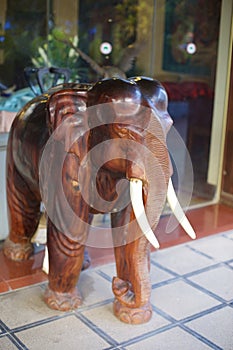 Wooden front hotel door elephant figure, Laos photo