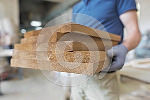 Wooden furniture details in hands of carpenter