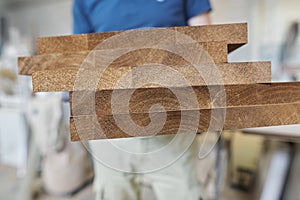 Wooden furniture details in hands of carpenter