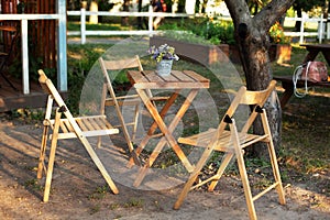 Wooden furniture set for Picnic in garden. Empty Wooden chairs and table on veranda of house. ÃÅ¾utdoor furniture for leisure time