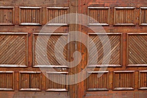 Wooden garage doors on an upscale house .