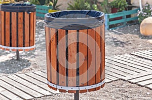 Wooden garbage can for rubbish on a beach on a summer day