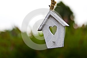 Wooden garden decor of white house with a heart