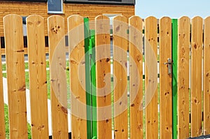 Wooden garden fence door. Wood fence - house wood fencing.