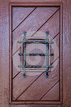 Wooden gate with barred window