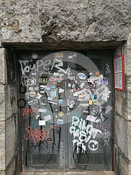 Wooden gate being painted with graffiti