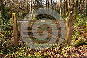 Wooden gate in a forest park with sign private no entry. Access to private property forbidden