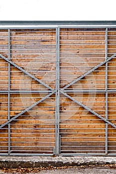 Wooden gate on metal frame covering locked area for tourists