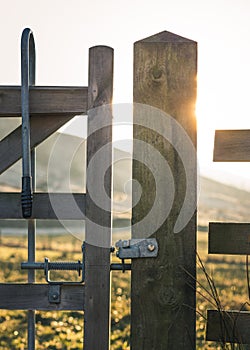 Wooden gate with metal opening mechanism