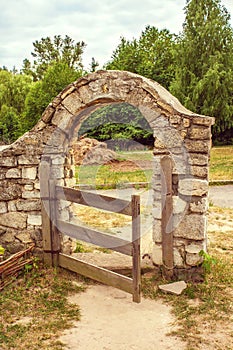 Wooden gate in the stone fence