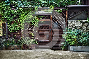 Wooden gate to enter the old courtyard from the street